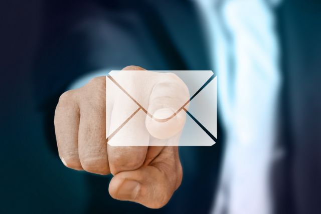 Picture of man pointing to email symbol on screen